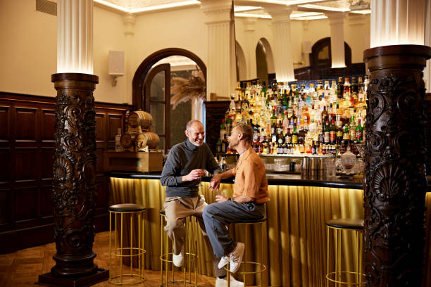 istock Gay men enjoying drinks in cocktail bar 2140979648