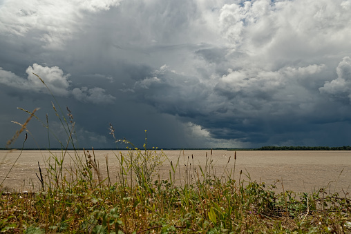 Cloudy stormy sky over the Maroon River. Threatening storm cloud. Meteorological phenomenon
