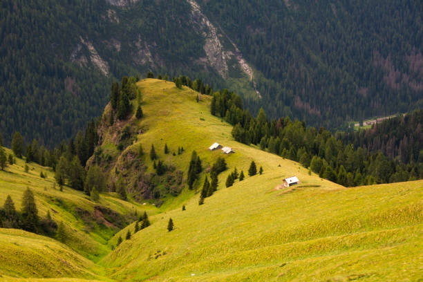 Alpine mountain landscape with a mountain hut on top of the rocky and snowy moutnain along the Timmelsjoch high mountain pass during a beautiful springtime day in the Italian Alps of South Tirol.