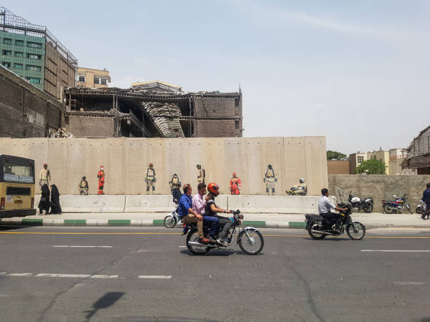 Tehran, IRAN - may 02, 2017 - Tehran's Republic Street (Jomhuri) and the ruins of Plasko Tower after the collapse and a view of those who worked hard to save the building and left (firemen)