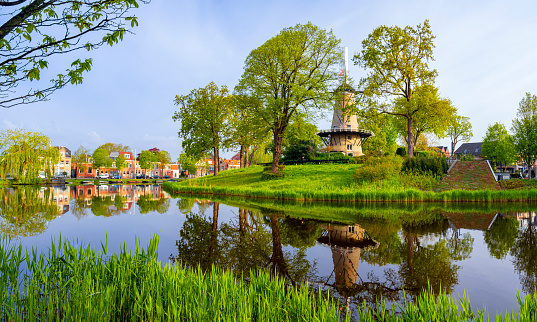 A windmill, the 'Molen van Piet', along a canal in Alkmaar, Netherlands