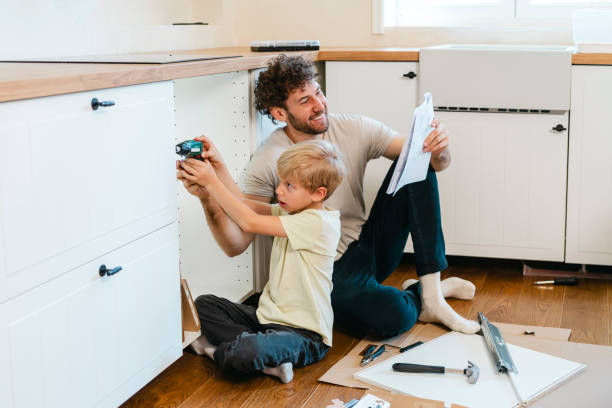 istock Father and son assembling kitchen furniture 2141000272