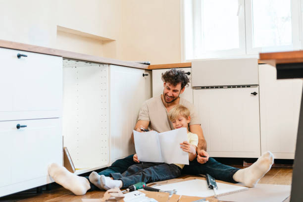 istock Father and son assembling kitchen furniture 2141000330