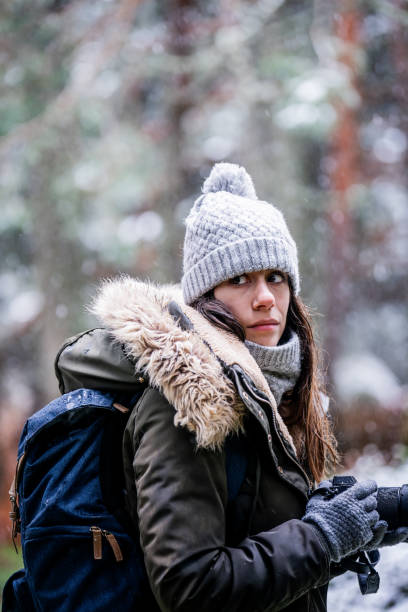 istock Exploring snow-clad Spanish forest, young Caucasian woman captures the landscape with her camera 2141011908