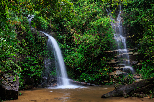Slow motion shot of the Montha Than waterfall in the luxuriant jungle of the Doi Suthep national park, Thailand.
