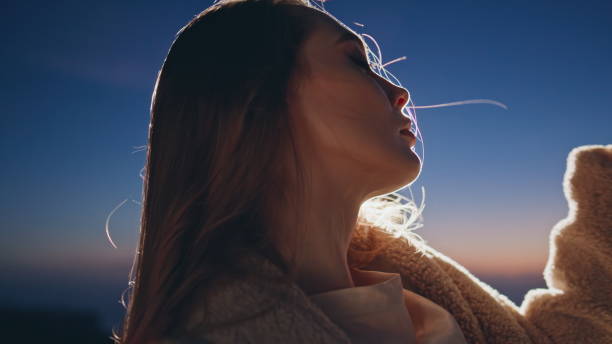 istock Closeup sensual lady partying at night sky background. Model posing at sunset 2141044037
