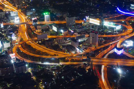 Bangkok, Thailand - 28 December, 2023: Night view on glowing Makkasan Interchange from Baiyoke Tower II in Bangkok, Thailand. One of the major expressway interchanges. Long exposure, top view