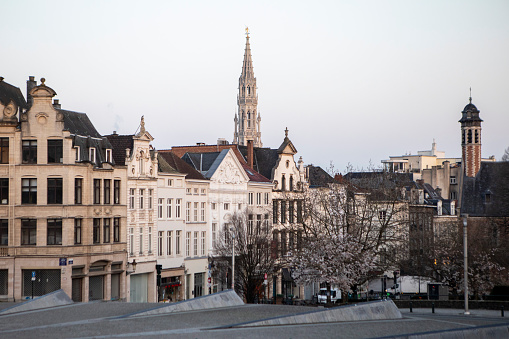 Early morning in Brussels. The Hotel de Ville can be seen on the horizon behind a row of buildings