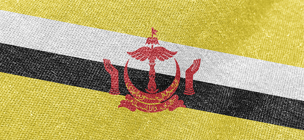 Brunei Darussalam flag fabric cotton material wide flag wallpaper, Textured national flag of Brunei Darussalam for graphic and web design purposes.