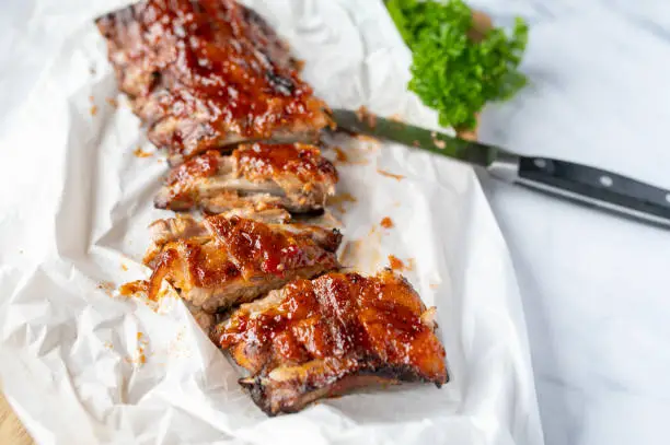 Fresh barbecue honey glazed pork ribs or spareribs on light background