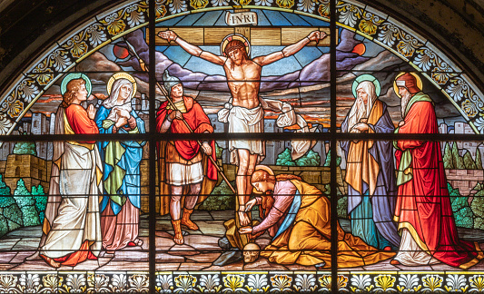 Milan - The crucifixion in the stained glass in the church Basilica di Santo Stefano Maggiore by Costante Panigati (1898).