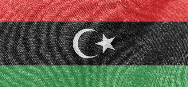 Libya flag fabric cotton material wide flag wallpaper, Textured national flag of Libya for graphic and web design purposes.