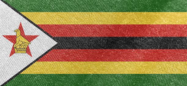 Zimbabwe flag fabric cotton material wide flag wallpaper, Textured national flag of Zimbabwe for graphic and web design purposes.