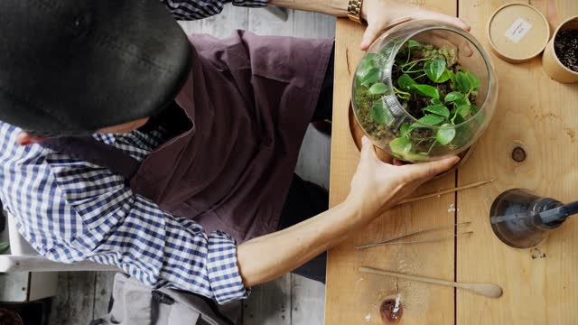 Mature man learning how to make a terrarium during a workshop