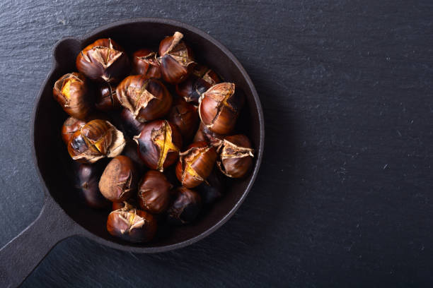 istock Tasty fried chestnut snack background 2141155519