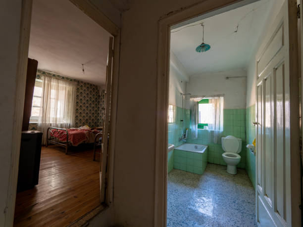 istock A small room with a green tile wall and a white toilet 2141174861