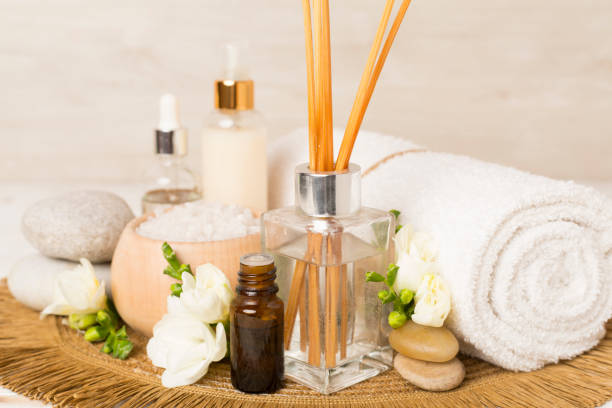 istock Spa composition with freesia flower and aroma diffuser on wooden table 2141176514