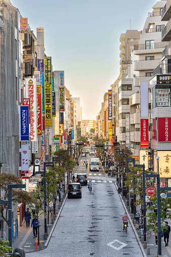 Tokyo, Japan - October 12, 2023: A view down a main street in Mitaka, Toyko as seen from the landing of the Mitaka train station platform, the stop for the Ghibli Museum.