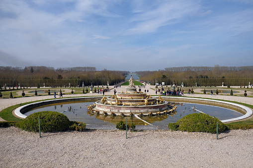 VERSAILLES, FRANCE - March 8, 2024. View of the gardens of the impressive Palace of Versailles, French castle and historic monument, the residence of the Sun King Louis XIV.