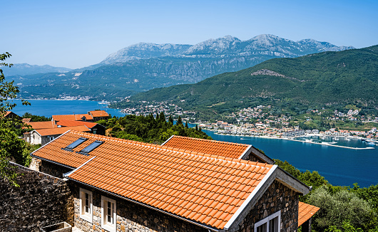 Kotor bay and Kotor town view in Montenegro from above with red roofs in the foreground. Scenic panorama on Adriatic sea and mountains