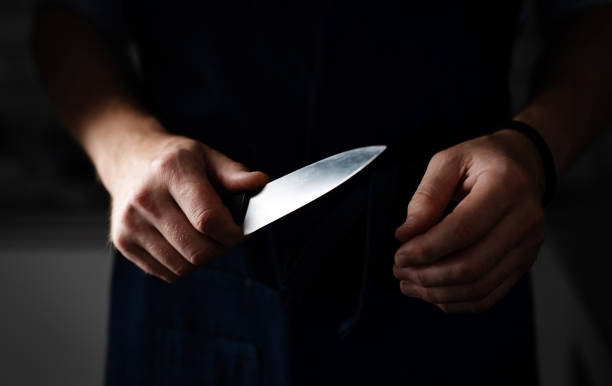 Dangerous Man Holds Sharp Knife In Darkness Dangerous Man Holds Sharp Knife In Hand In Darkness, Murder Concept rough hands man stock pictures, royalty-free photos & images
