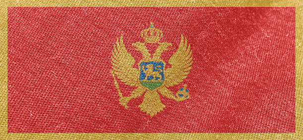 Montenegro flag fabric cotton material wide flag wallpaper, Textured national flag of Montenegro for graphic and web design purposes.