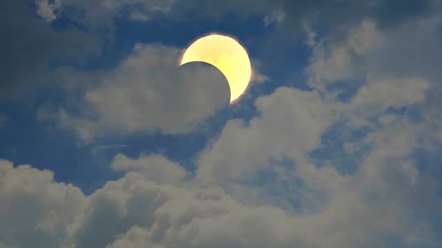 solar eclipse with heap white cloud blue sky huge rollong time lapse