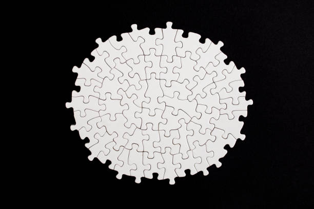 istock Plain white jigsaw puzzle  on black color background, oval shaped frame, abstract backdrop 2141233852