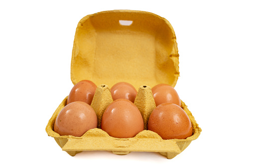 6 eggs yellow carton pack, front view isolated on white