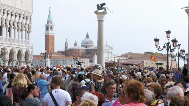 Crowd of people walking on the square of St. Mark, Venice, Italy