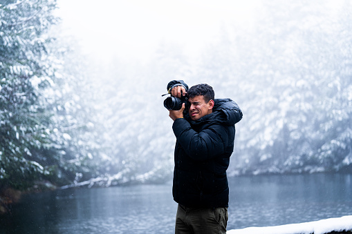 Exploring wintry Sierra de Guadarrama, Hispanic traveler captures stunning snowy scenery.