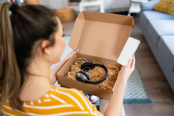 istock Young woman unpacking her online order 2141283487
