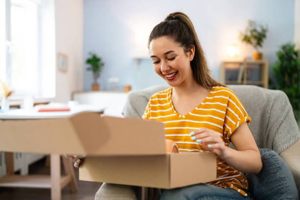 istock Young woman unpacking her online order 2141284571