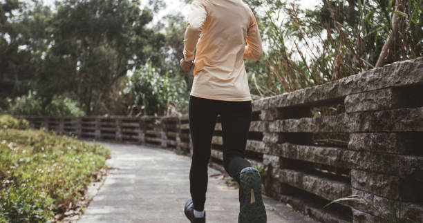 istock Asian woman jogging in park 2141291456