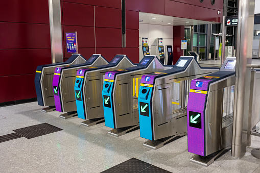 Hong Kong - April 3, 2024 : Fare gates at the MTR Hung Hom Station in Hong Kong. Passengers can pay the fare by Octopus, Single Journey Ticket, QR code e-wallets, or contactless credit card payment.