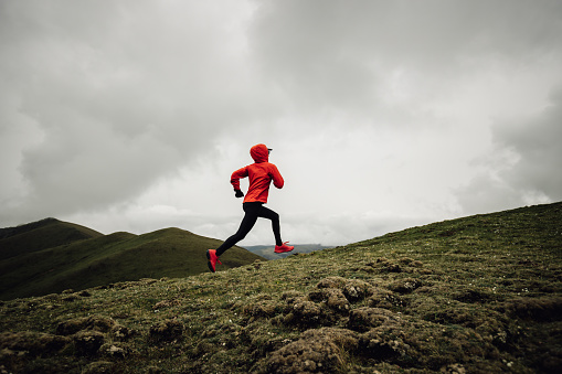 Woman runner running at mountain top