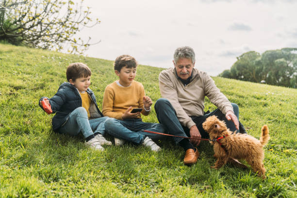 istock Grandfather and grandson using phone 2141317460