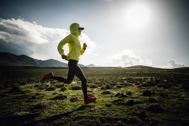 istock Woman runner running at mountain top 2141342244