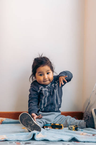 vertical child playing with cars at home - fun concept