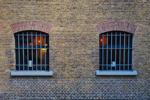 Leeuwarden, Netherlands, June 8, 2023. Barred cell windows in the old brick wall of a 19th-century prison in Leeuwarden, the Netherlands