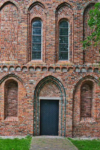 Appingedam, Netherlands, Nov. 8, 2023. Side entrance with open and bricked-up windows of the Romano-gothic St Nicholas Church (Nicolaaskerk) in the town of Appingedam, province of Groningen, the Netherlands