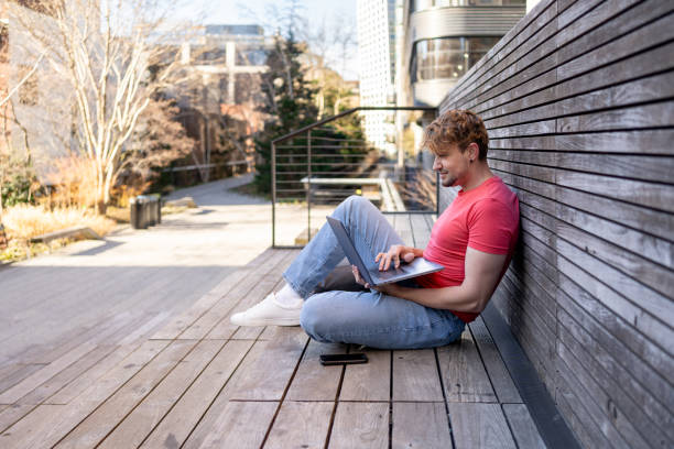 istock Latin man using a laptop at a sustainable area in NYC 2141420261