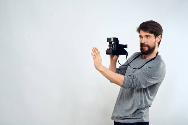 Male photographer professional camera work Studio Technology modern art light background. High quality photo