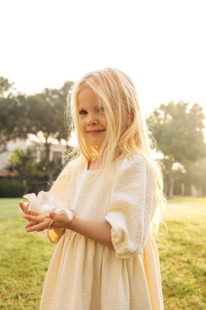 Happy child girl in the forest, walking, playful. Soft blurred sunlight. Enjoying Life and nature. Beaming light and atmospheric mood, cinematic blurred effect. Golden hour