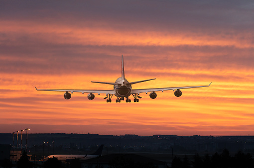 Passenger airplane is Landing at dusk