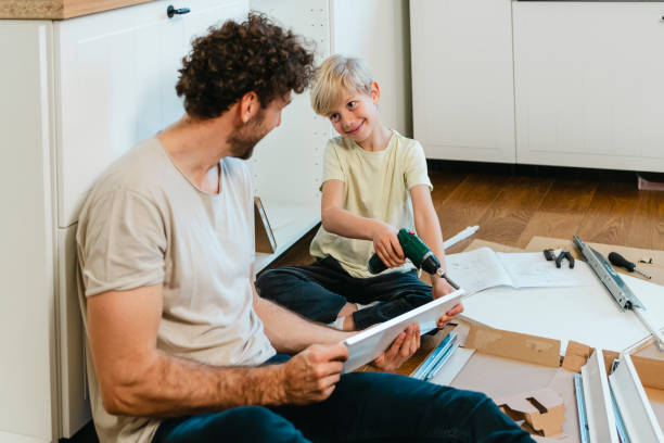 istock Father and son assembling kitchen furniture 2141461474