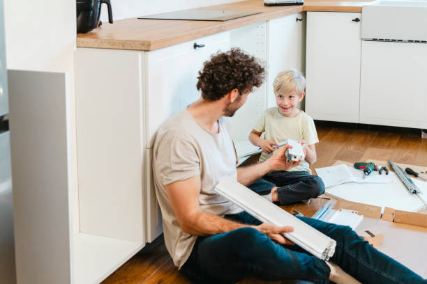 istock Father and son assembling kitchen furniture 2141462578