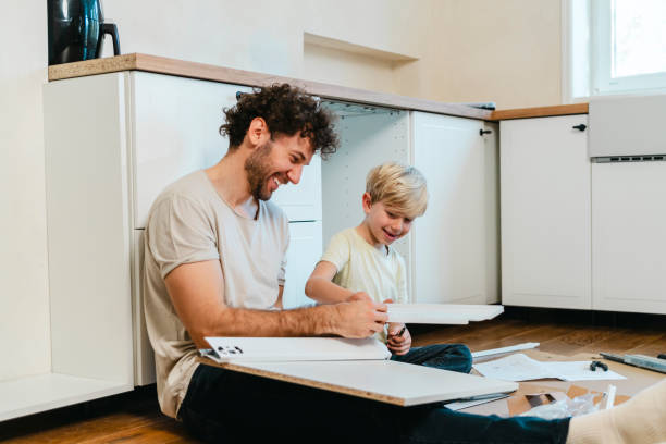 istock Father and son assembling kitchen furniture 2141463640