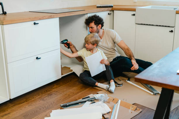 istock Father and son assembling kitchen furniture 2141465214