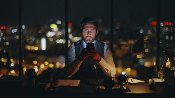 istock Worker typing smartphone night office zoom on. Serious boss messaging online 2141510819